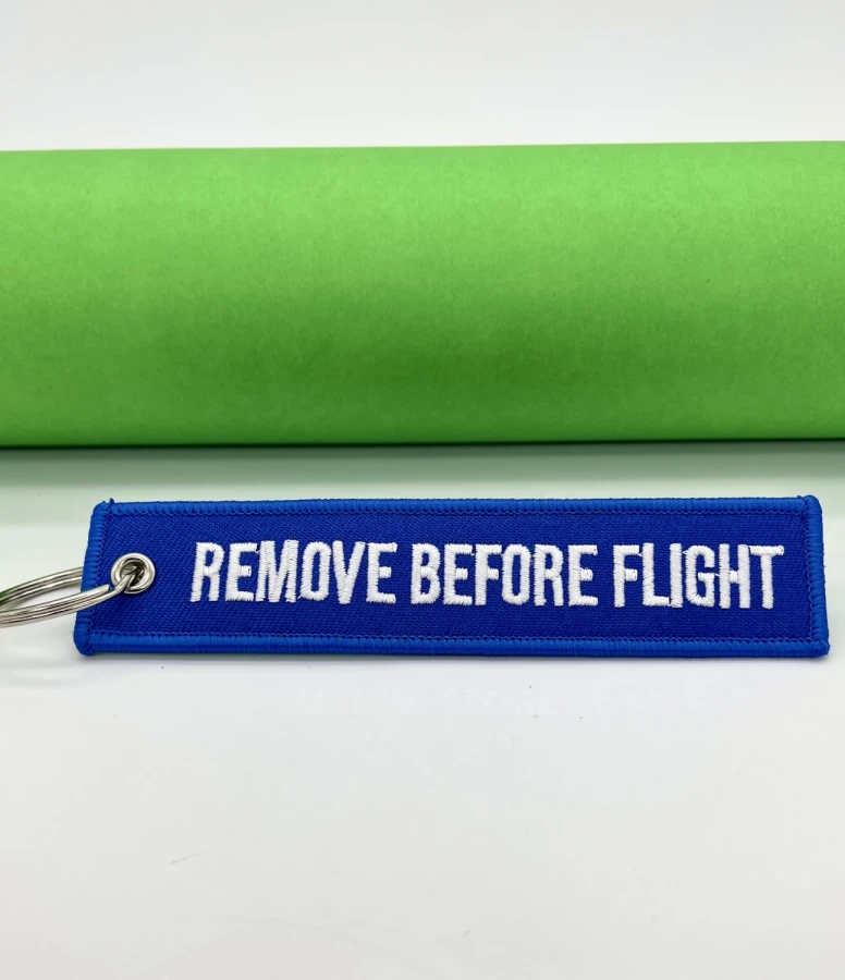 Remove Before Flight light blue Keychain