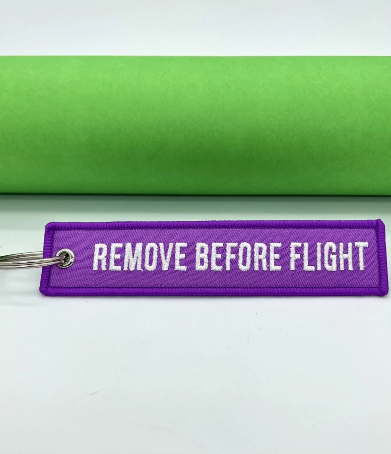 Remove Before Flight purple Keychain