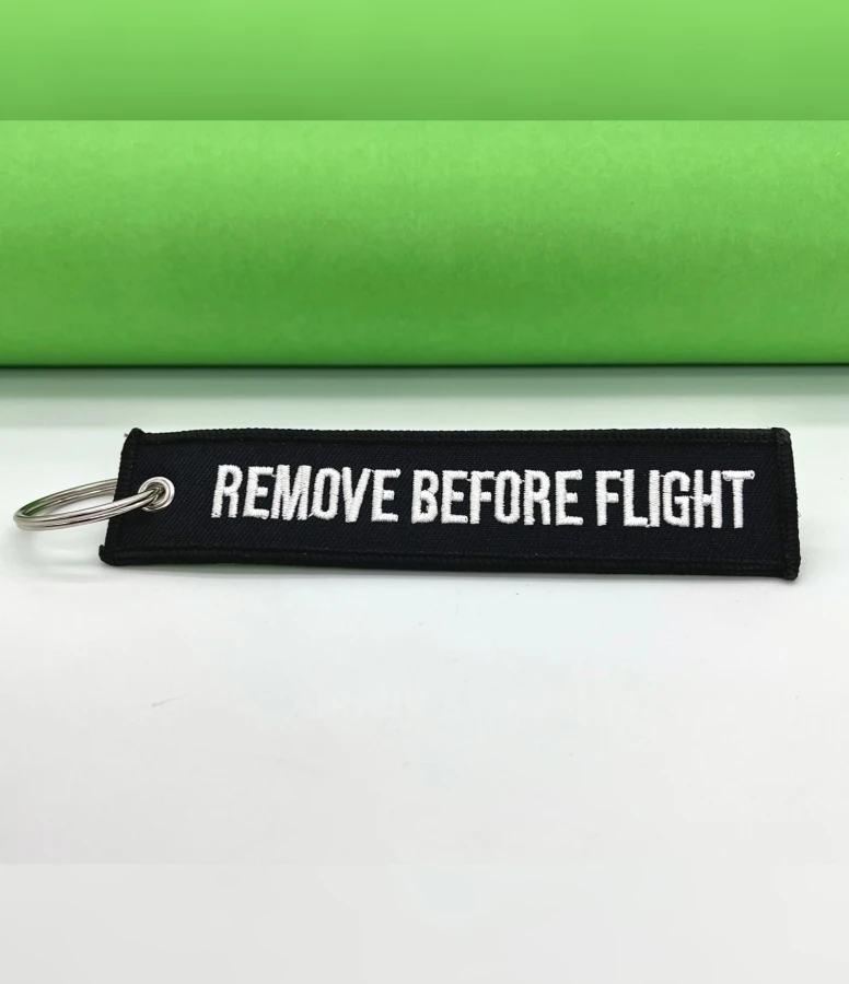 Remove Before Flight black Keychain